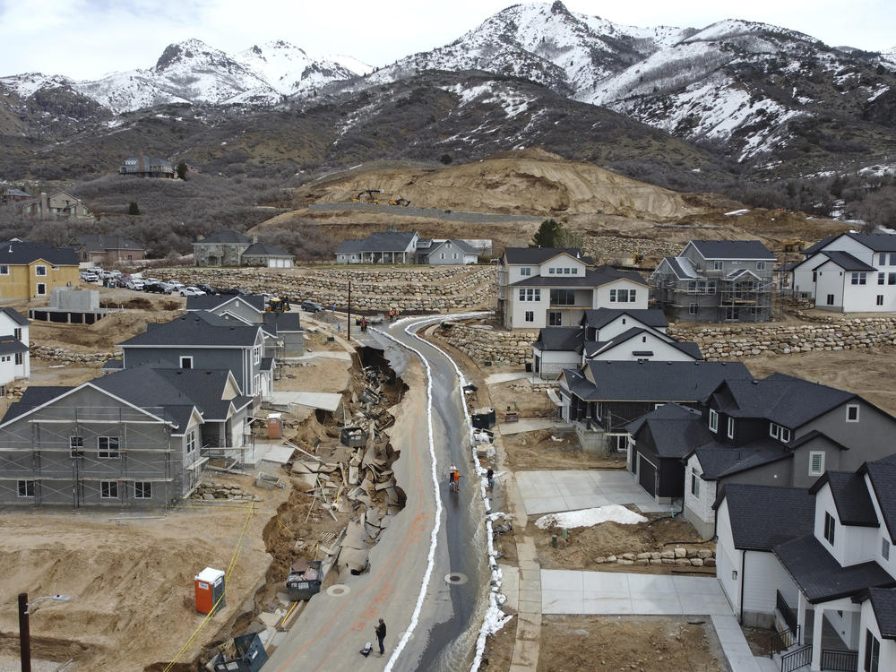 Local officials issued evacuation orders for at least 20 homes as temperatures spiked and snowmelt coursed through the streets on Wednesday, April 12, 2023, in Kaysville, Utah. A record-breaking snow season has raised fears of spring flooding throughout Utah as the weather in mountain regions warms.