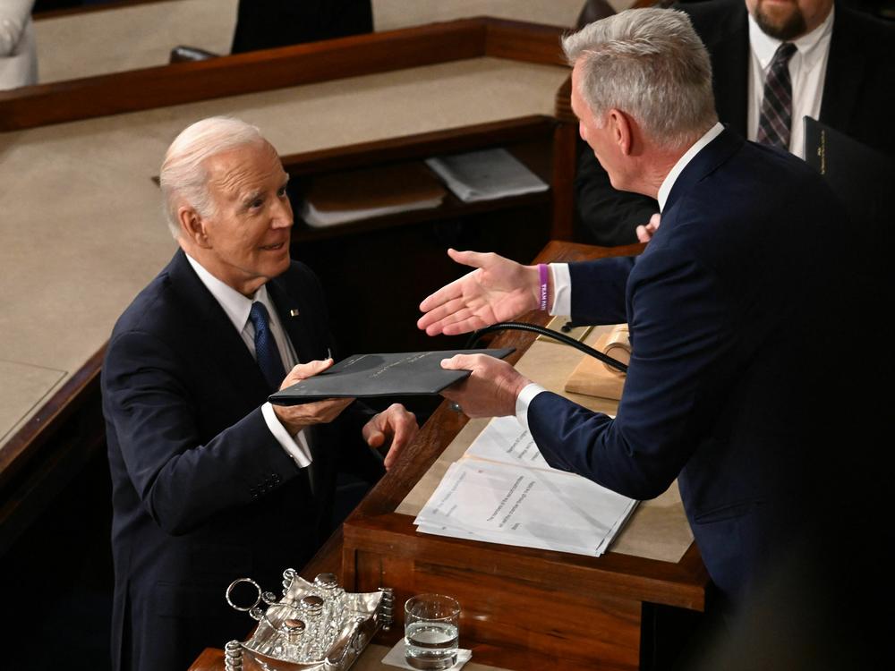 President Biden hands Speaker Kevin McCarthy a copy of his State of the Union address on Feb. 7.