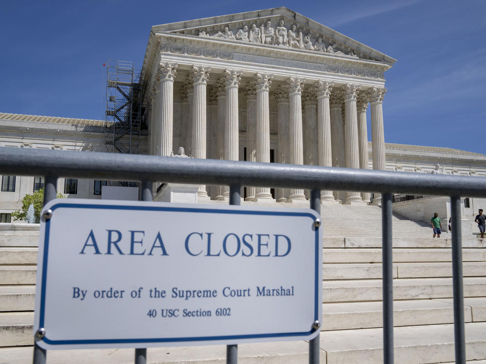 Security fencing is seen as people visit the Supreme Court on April 19.