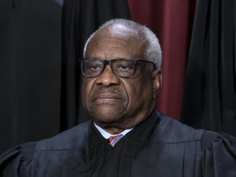 Associate Justice Clarence Thomas joins other members of the Supreme Court as they pose for a new group portrait at the Supreme Court building in Washington on Oct. 7, 2022.