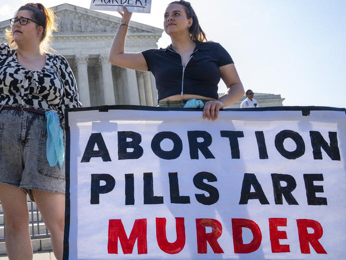 Anti-abortion advocates demonstrate against abortion pills outside the Supreme Court on Friday.
