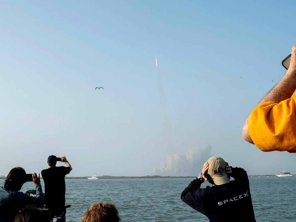 Spectators watch from South Padre Island, Texas, as the SpaceX Starship launches on Thursday. It exploded several minutes later.