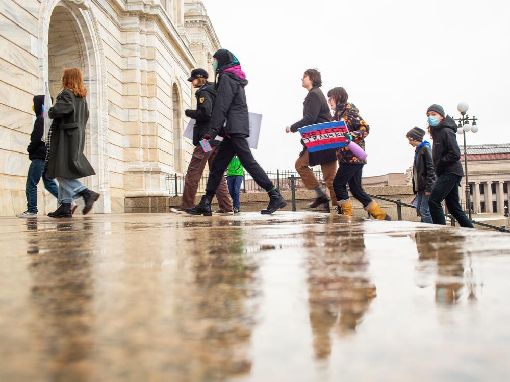 Activists and community members march into the Minnesota State Capitol building during a Trans Day of Visibility rally on March 31, 2023.