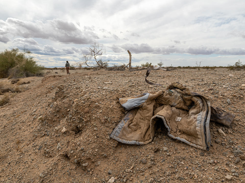 Jacqueline Arellano hikes through a wash she suspects migrants move though on their way north after crossing the border. She volunteers with Border Kindness , a group that is extending its services to  desert areas around Yuma, Ariz., to assist lost or hurt migrants.