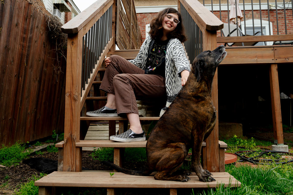 Chelsea Freels, 17, pets her dog Sophia on April 20, 2023, outside her home in Richmond Heights, Mo.