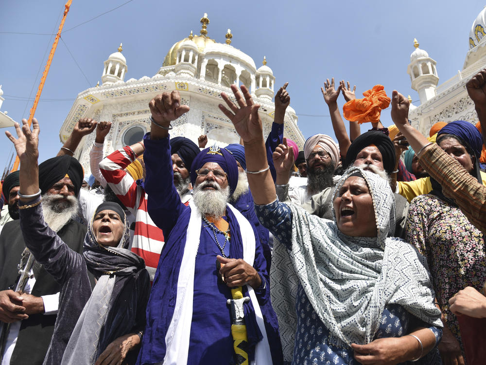 Supporters of Waris Punjab De organization shout slogans favoring their chief and separatist leader Amritpal Singh and other arrested activists during a meeting at the Akal Takht Secretariat inside Golden Temple complex, in Amritsar, India, on March 27, 2023.