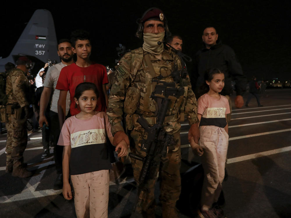 Jordanians evacuated from Sudan arrive at a military airport in Amman, Jordan, Monday, April 24, 2023.
