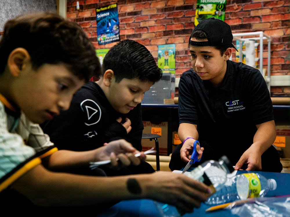 Christopher Olivarez, 15, helps students build model bottle rockets in Patrice Bravo's STEM lab at Nora Forester Elementary School in San Antonio, Texas.