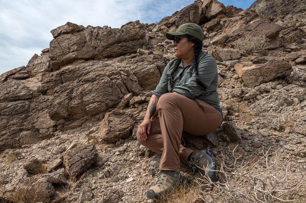 Jacqueline Arellano hikes through a canyon she suspects migrants use on their way north after crossing the border.