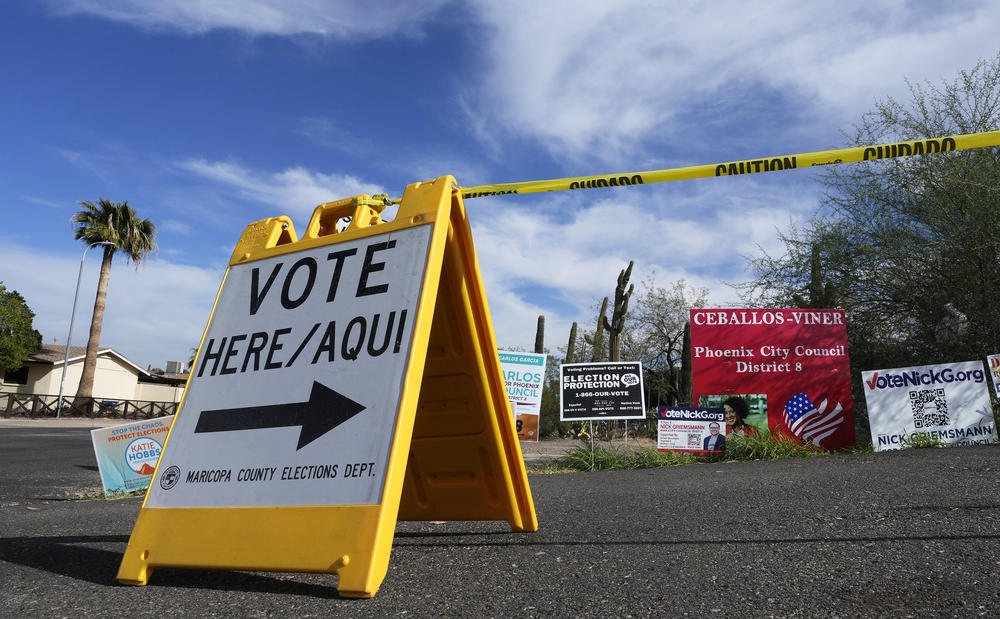A sign points voters in the right direction to drop off ballots in Phoenix on Nov. 7, 2022.