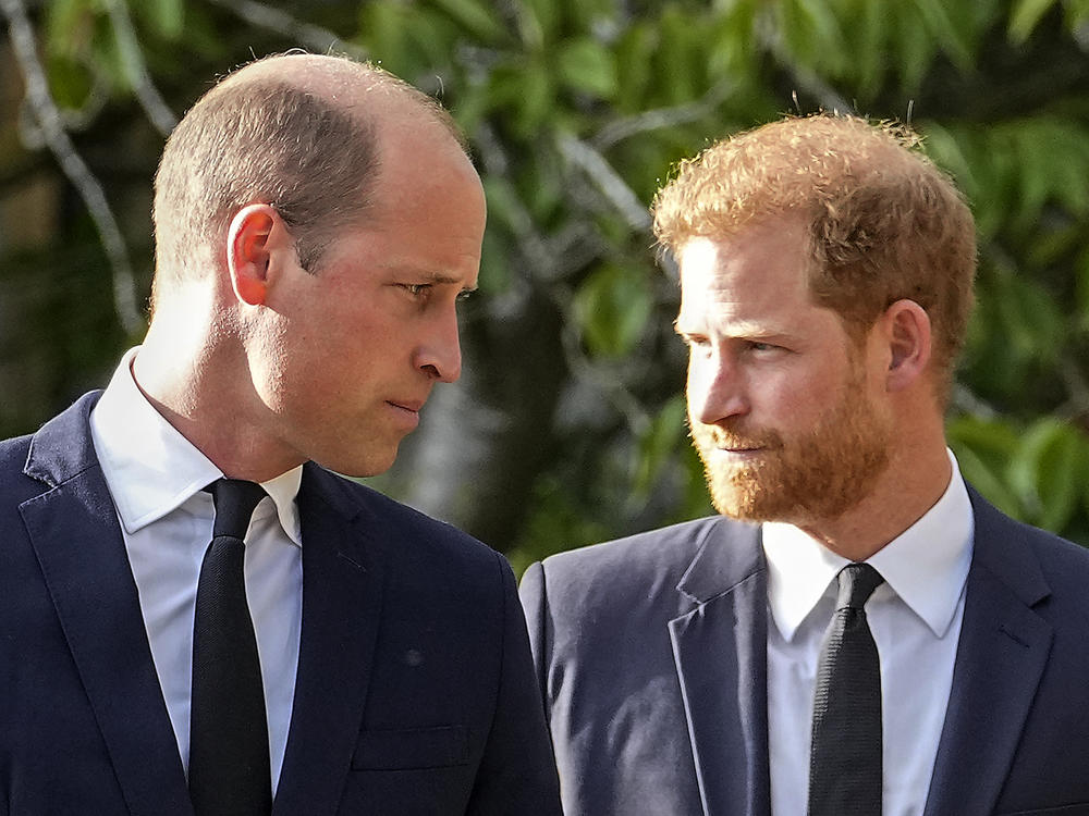 Prince William and Prince Harry walk after viewing tributes for the late Queen Elizabeth II outside Windsor Castle last September. Court papers say Prince William received 
