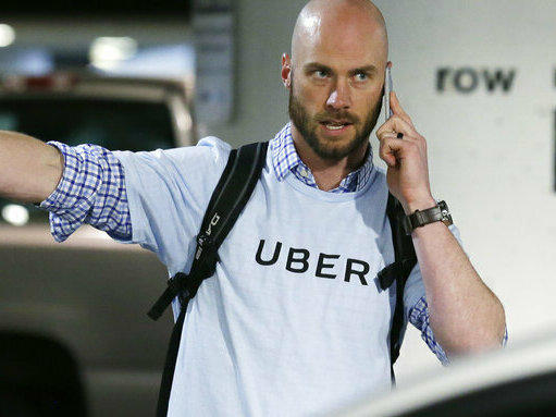 A senior operations manager for Uber directs drivers at the Seattle-Tacoma International Airport.