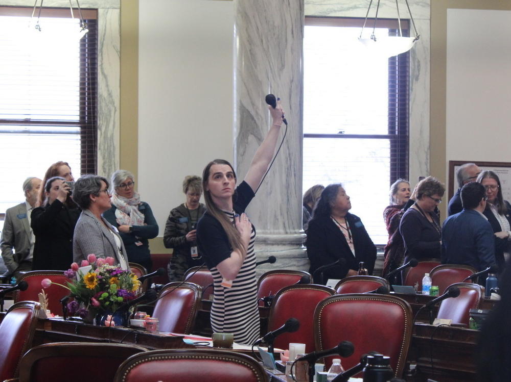 Rep. Zooey Zephyr on the Montana House floor as protesters chant 