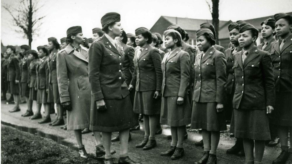 Maj. Charity Adams (foreground) and Capt. Abbie N. Campbell inspect a contingent of the Women's Army Corps shortly after their arrival in England on Feb. 15, 1945.