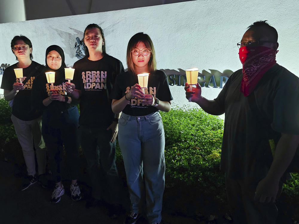 In this image taken and provided by Anti-Death Penalty Asia Network, members of Anti-Death Penalty Asia Network (ADPAN) hold candle outside Singapore Embassy in Kuala Lumpur, Malaysia Wednesday, April 26, 2023.