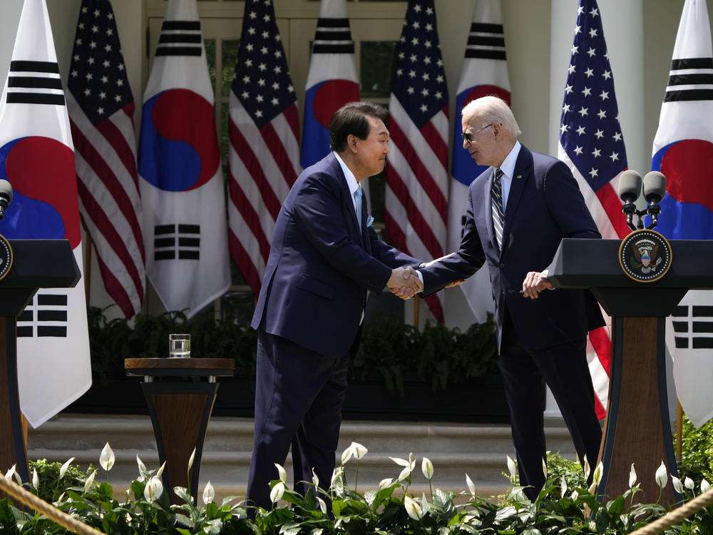 President Biden and South Korean President Yoon Suk Yeol shake hands during a press conference in the Rose Garden at the White House.