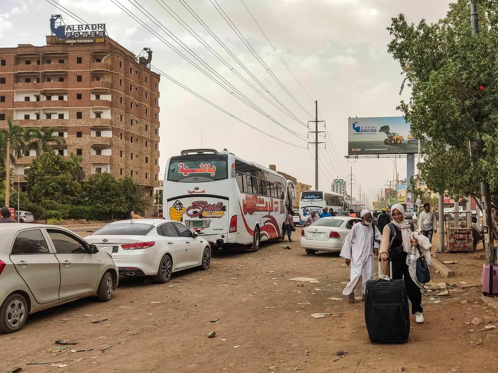 People prepare to board a bus departing Khartoum on April 24, as battles rage in the city between the army and paramilitaries.