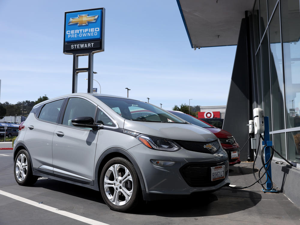 A Chevrolet Bolt EV is parked at a charging station at a dealer in Colma, Calif., on Tuesday.