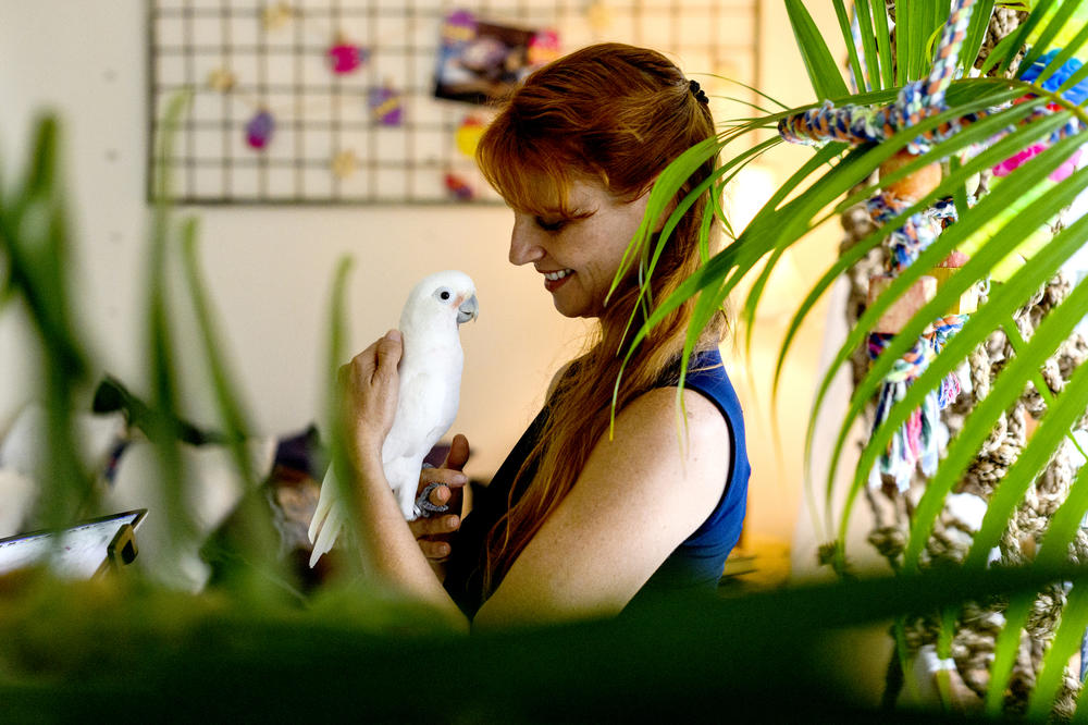 Jennifer Cunha with Ellie the cockatoo at her home in Florida.