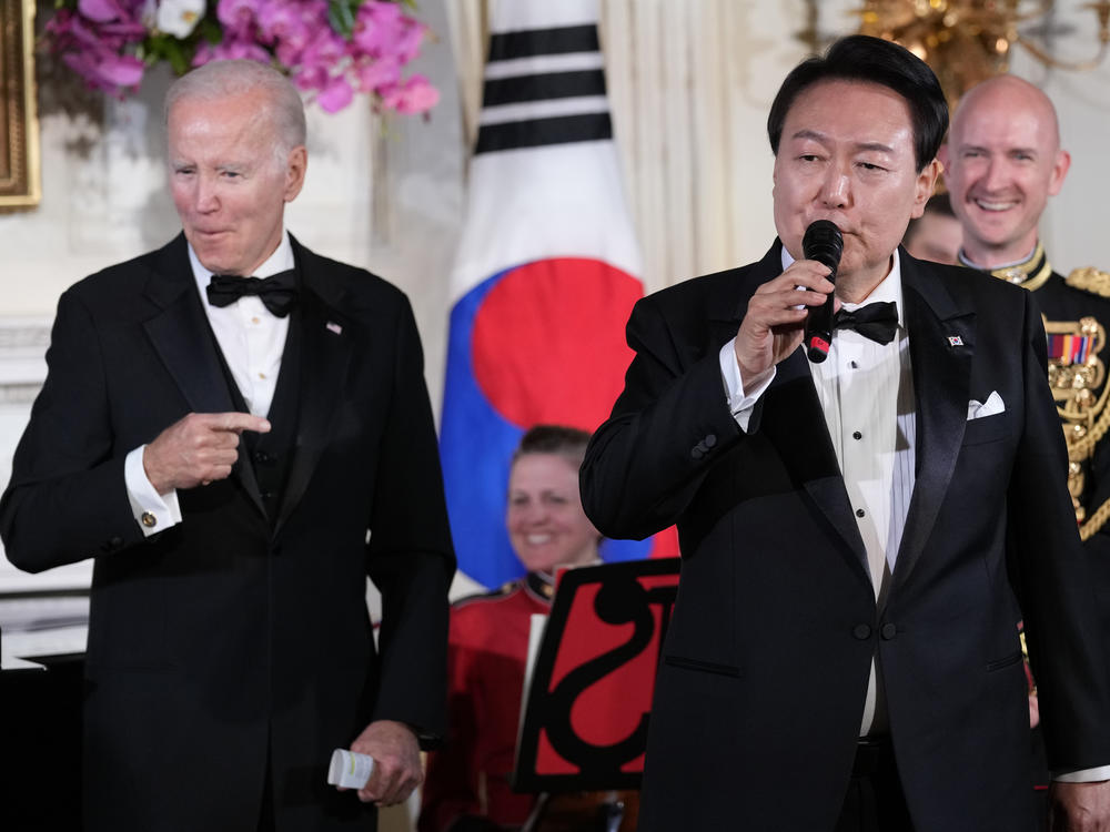 President Joe Biden reacts as South Korean President Yoon Suk Yeol sings the song 