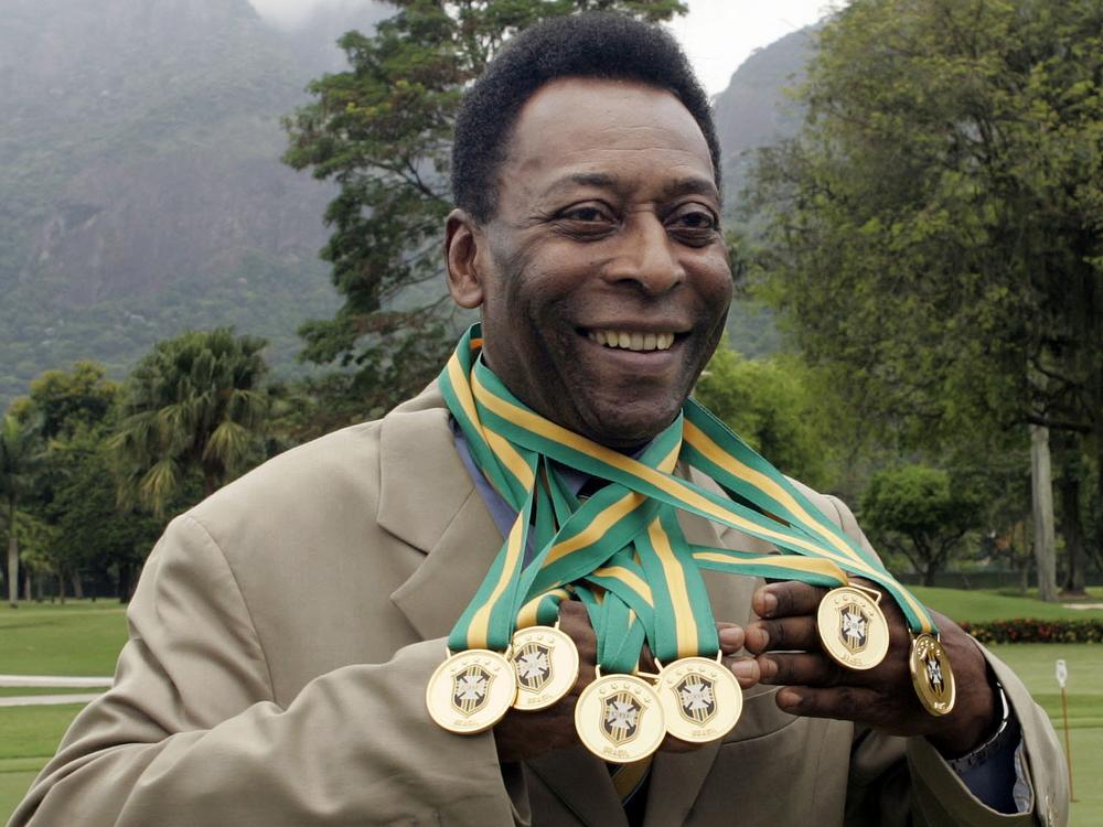 Brazilian football legend Edson Arantes do Nascimento, better known as Pelé, poses with his six Brazil's champion medals in 2010. A Portuguese language dictionary has recognized his name as a synonym for greatness.