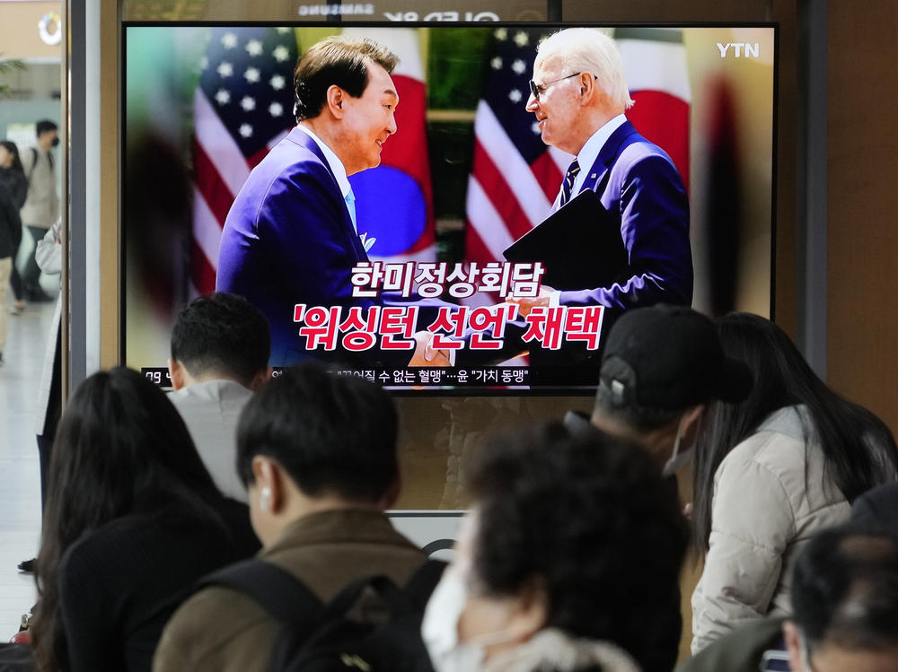 A TV screen shows an image of President Joe Biden and South Korean President Yoon Suk Yeol in Washington, at the Seoul Railway Station in Seoul, South Korea, on Thursday. Biden and Yoon unveiled a new plan Wednesday to counter North Korea's nuclear threat. The words read 