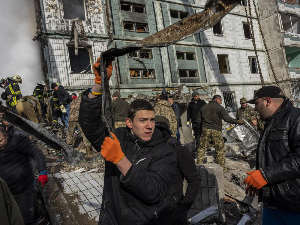 Following a Russian attack, first responders remove rubble at a residential building in Uman, central Ukraine on Friday.