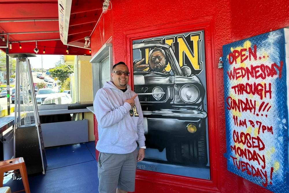 Mark Legaspi points to a painting of his cousin Jun Anabo at the successful Filipino restaurant they founded together. 