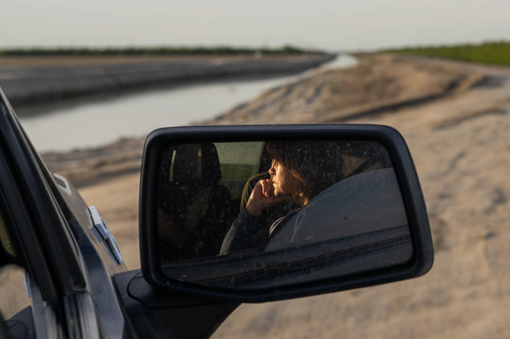 Judy Mendes looks at a levee near her house in Corcoran.