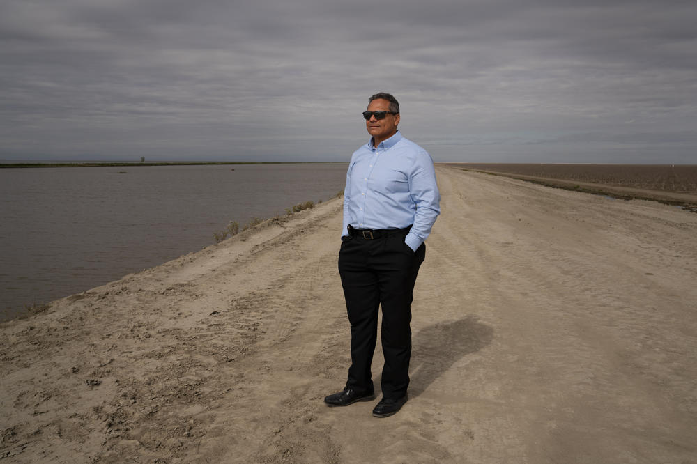 Greg Gatzka, the city manager of Corcoran, Calif., looks out at floodwaters that threaten his city.