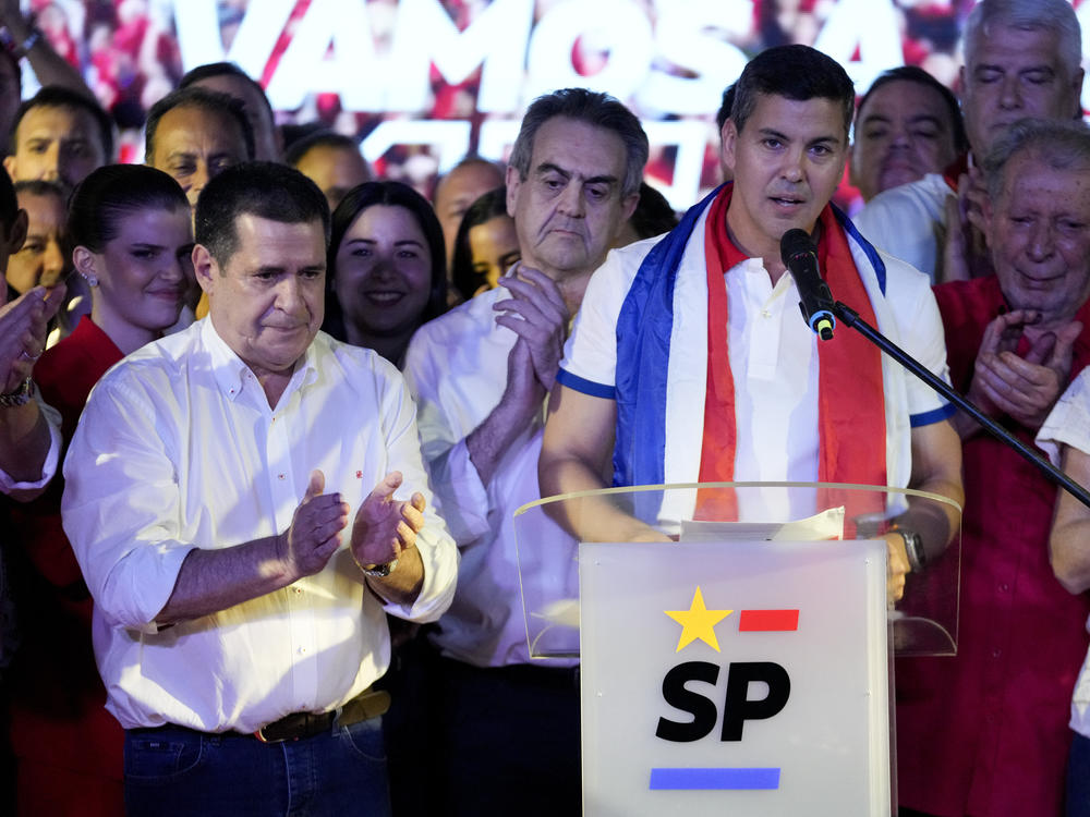 Santiago Peña, presidential candidate of the Colorado ruling party, right, talks beside former President Horacio Cartes after the voting closed during general elections in Asuncion, Paraguay, Sunday, April 30, 2023.