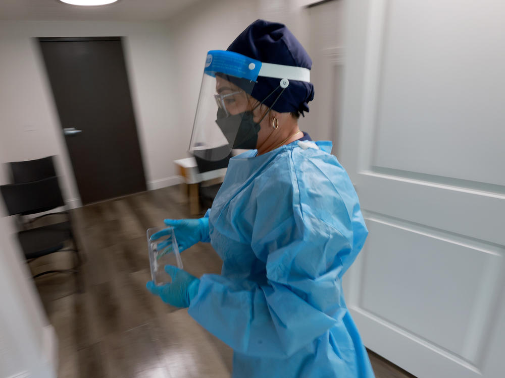 Miriala Gonzalez, a registered nurse in Miami, carries a monkeypox vaccine. A new survey highlights major concerns from nurses nationwide regarding future staffing levels in hospitals.