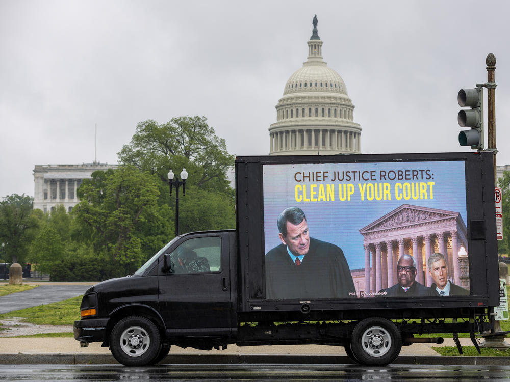A mobile billboard showing Supreme Court Chief Justice Roberts passes the U.S. Capitol on Friday.
