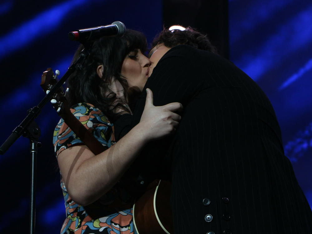 Mya Byrne (right) and her partner Swan Real embrace following a performance of Byrne's song 