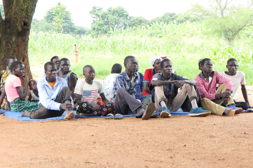 Adolescents and children with nodding syndrome attend a community health camp in the village of Ayom. They attend with their parents, and receive medication and additional treatment from wounds and seizures caused by the disease.