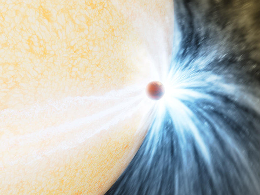 An artist's impression of an aging star swelling up and beginning to engulf a planet, much like the Sun will do in about 5 billion years.