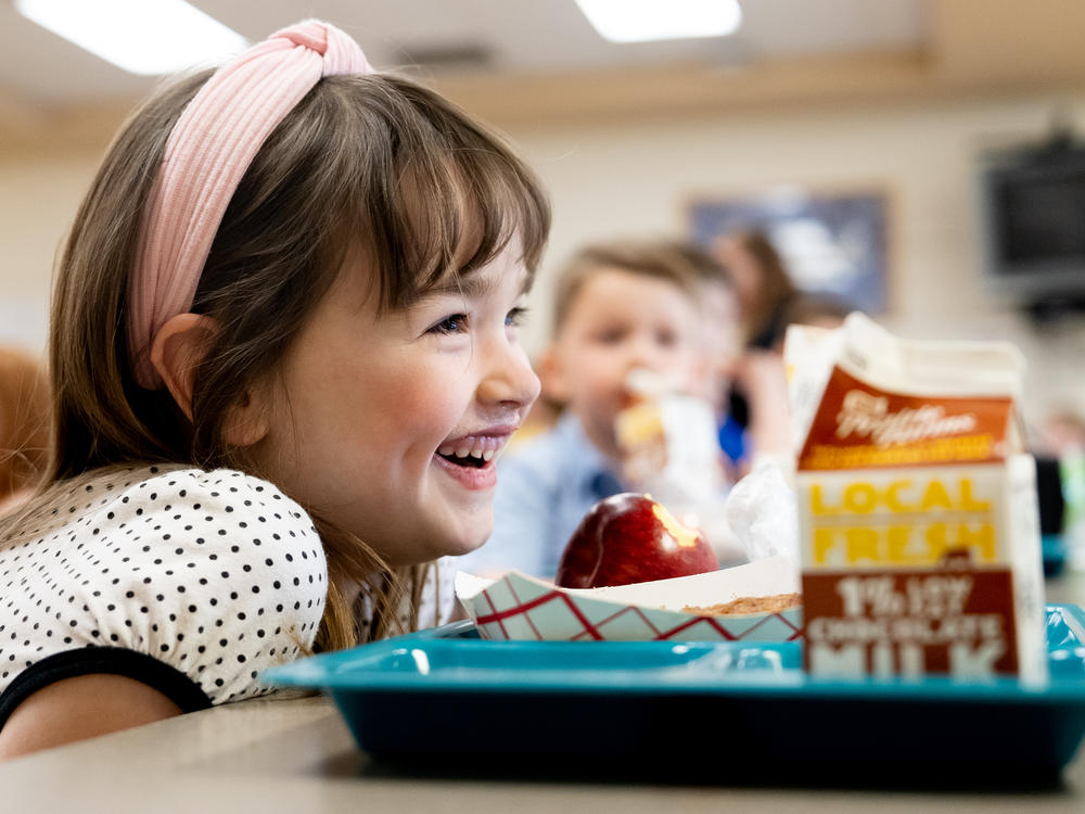 Amelia, a 5-year-old student at Oakville Elementary School, socializes during lunch in March at the school in Oakville, Mo. Kids who eat school meals tend to have a healthier diet.