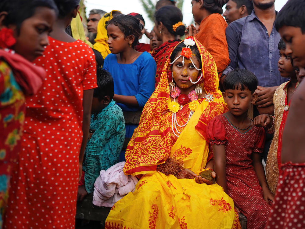 A 14-year-old schoolgirl in Bangladesh poses with friends and neighbors on her wedding day. A new UNESCO report looks at progress — and the lack thereof — in ending child marriage.