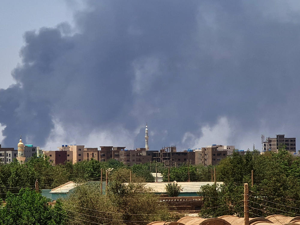 Smoke billows over buildings in Khartoum on May 1, 2023 as deadly clashes between rival generals' forces have entered their third week.