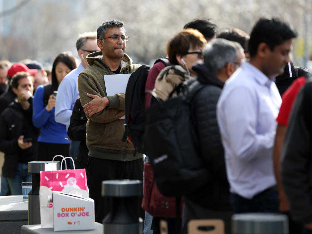People line up outside a Silicon Valley Bank office in Santa Clara, Calif., on March 13. Days after Silicon Valley Bank collapsed, customers lined up to try to retrieve their money from the failed bank.