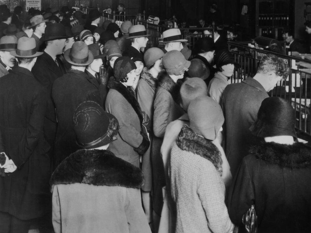 Investors rush to withdraw their savings during a stock market crash, circa 1929.