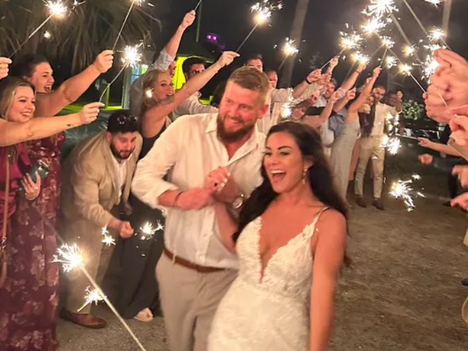 Aric Hutchinson and Samantha Miller are pictured at their wedding on Friday in a photo on a GoFundMe page. They were traveling in a golf cart hours later when a driver struck, killing Miller and injuring Hutchinson and two others.