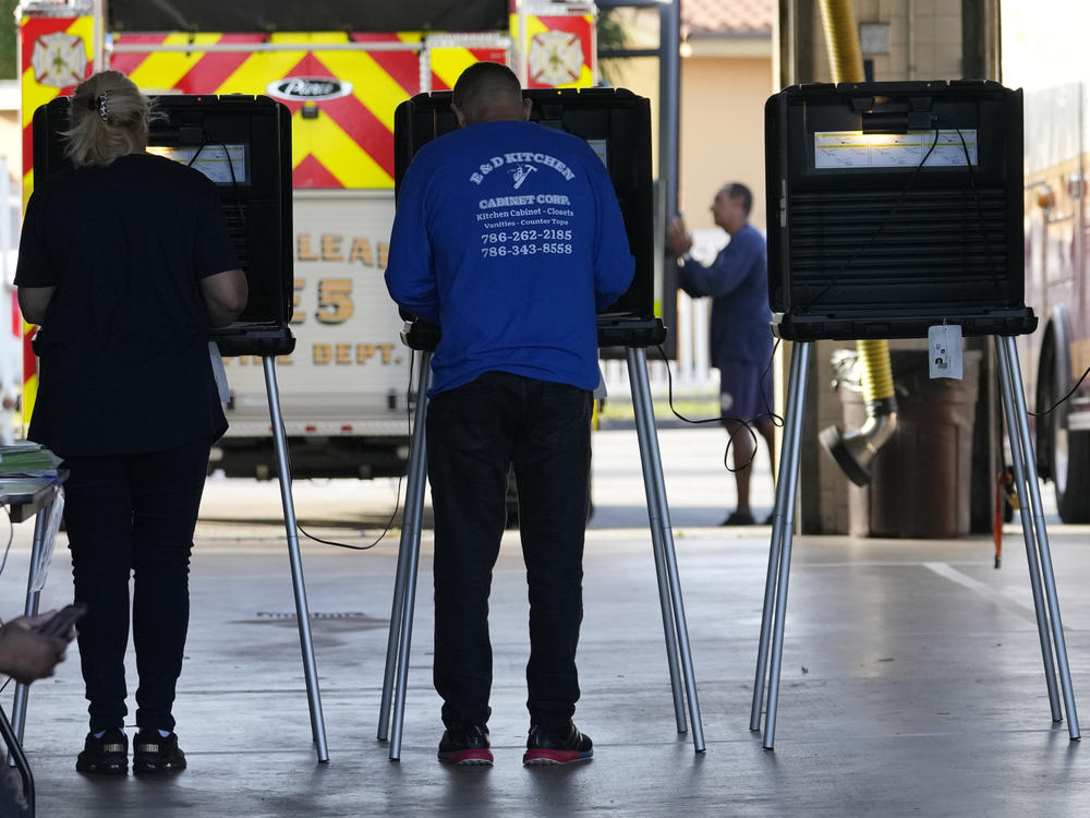 People vote in the midterm elections on Nov. 8, 2022, at a fire station in Hialeah, Fla.