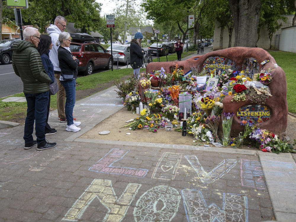 People view a memorial set up at the compassion bench in Davis, Calif., on Monday, May 1, 2023, to honor David Henry Breaux, 50 years old, who was found stabbed to death in Central Park.