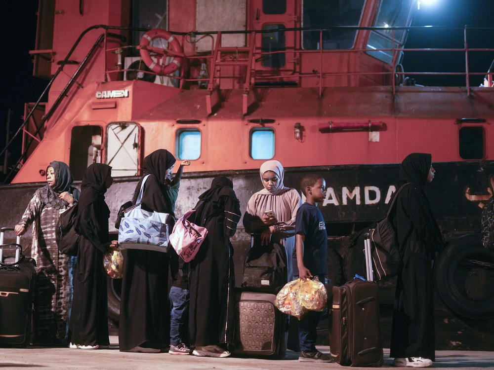 Sudanese evacuees wait before boarding a Saudi military ship to Jeddah port, at Port Sudan in Sudan, Wednesday, May 3, 2023. Many are fleeing the conflict in Sudan between the military and a rival paramilitary force.