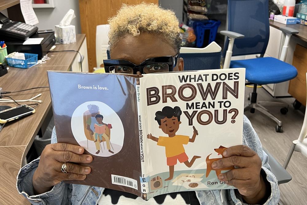 Children's librarian Stacie Madkins looks at books for story time at the Craighead County Jonesboro Public Library. Because of funding cuts, local libraries are slashing spending and staff. Some branches might have to close.