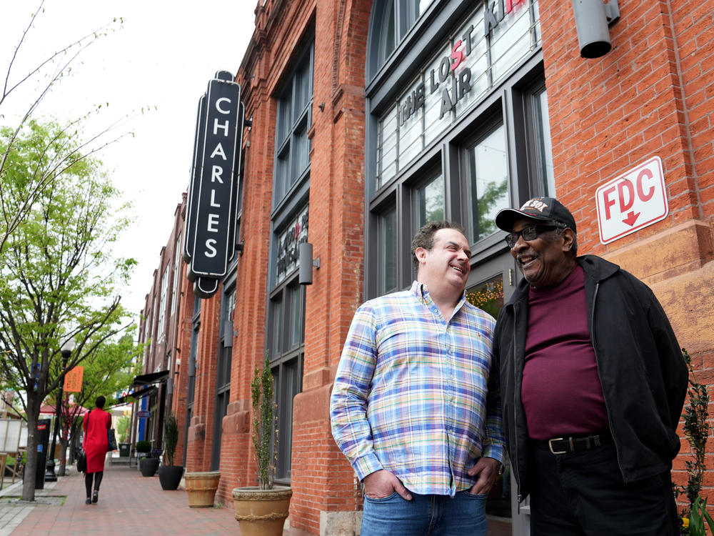 Record producer Zev Feldman (left) and John Fowler, a charter member of the Left Bank Jazz Society, meet outside the Charles Theater in downtown Baltimore. The building once hosted some of the best jazz musicians in the country.