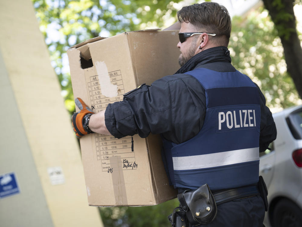 Police officers secure evidence during a raid in Mainz, Germany, Wednesday, May 3, 2023. Police arrested suspects and raided homes early Wednesday across Germany in a massive effort to clamp down on members of an Italian organized crime syndicate.
