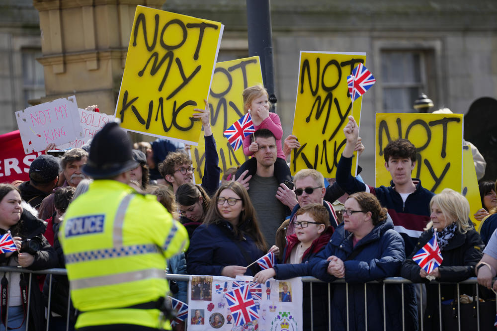 Protesters wait for the arrival of King Charles III and Camilla, the queen consort, in Liverpool, England, on April 26. Dissenters will be among the cheering crowds when Charles travels to his coronation. More than 1,500 protesters will be dressed in yellow for maximum visibility, and they plan to gather along the parade route to chant 