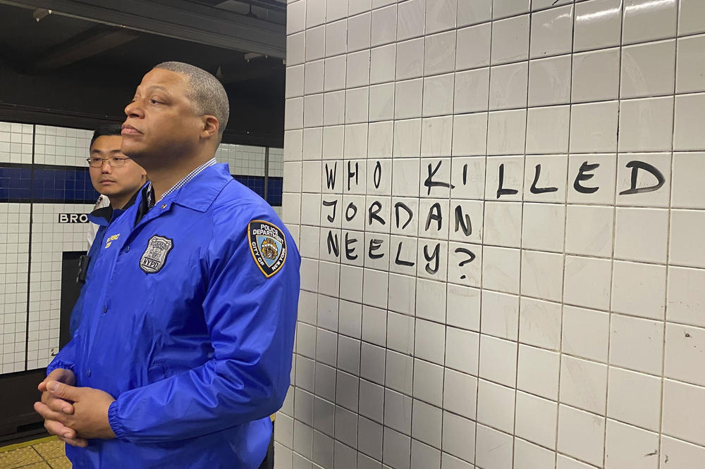 Police officers watch Wednesday as protesters gather in the Broadway-Lafayette subway station to protest the death of Jordan Neely in New York. Neely, a man who was suffering an apparent mental health episode aboard a subway car, died after being placed in a headlock by a fellow rider on Monday.